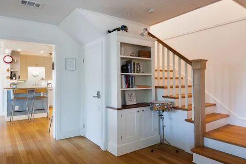 a view of workspace with wooden floor and bedroom view