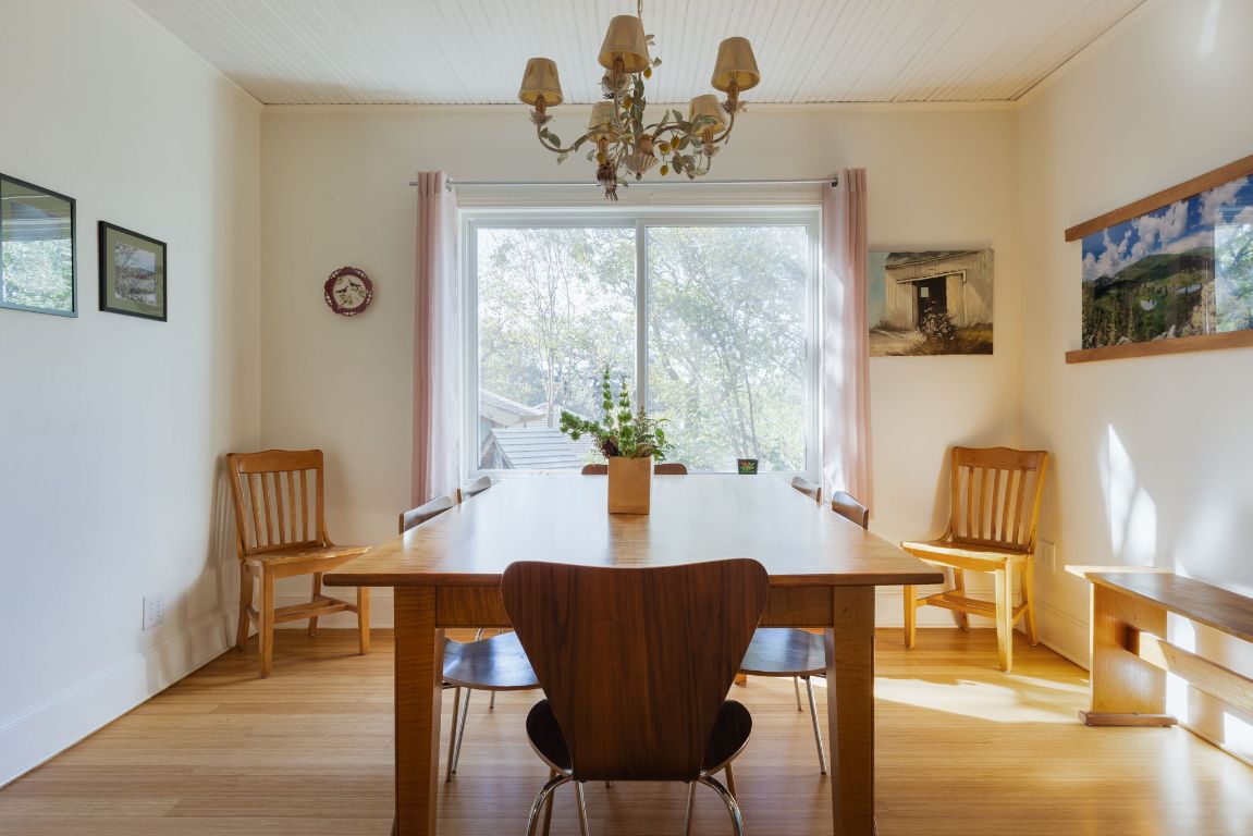 2102 Travis Heights Boulevard Austin, TX 78704 - Photo 8 of 28 a view of a dining room with furniture a chandelier and wooden floor