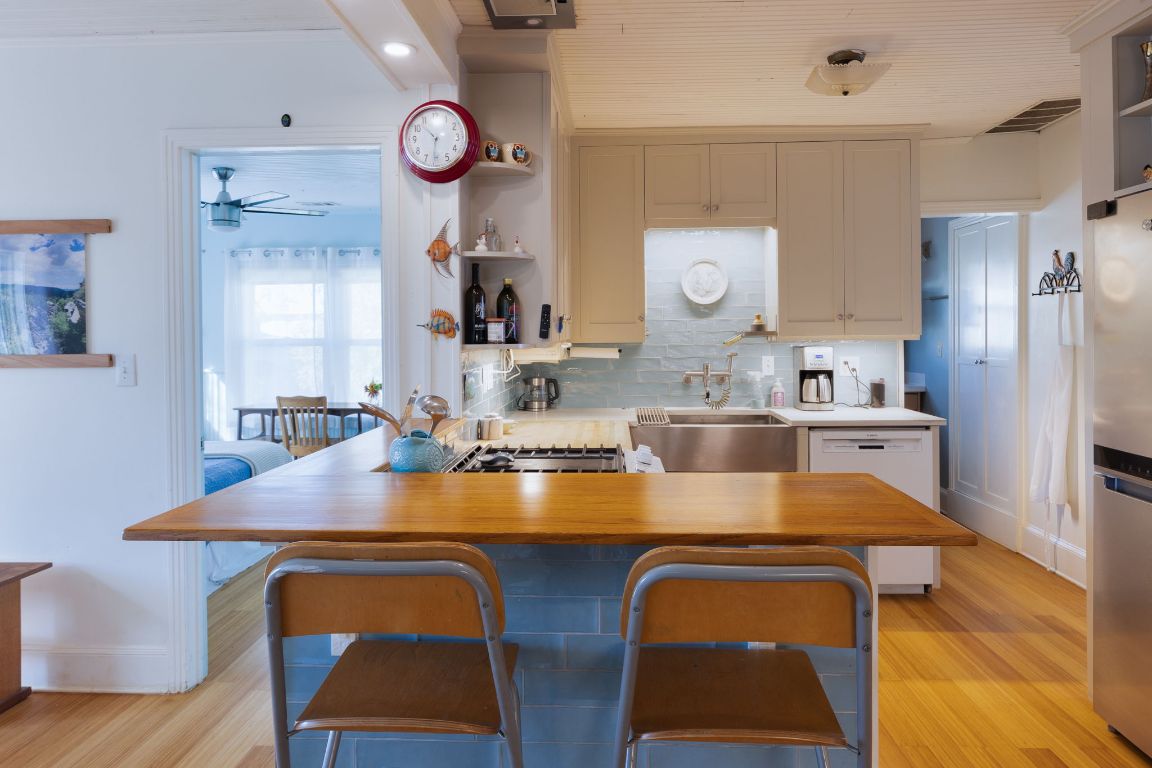 2102 Travis Heights Boulevard Austin, TX 78704 - Photo 10 of 28 a kitchen with a table chairs and a stove