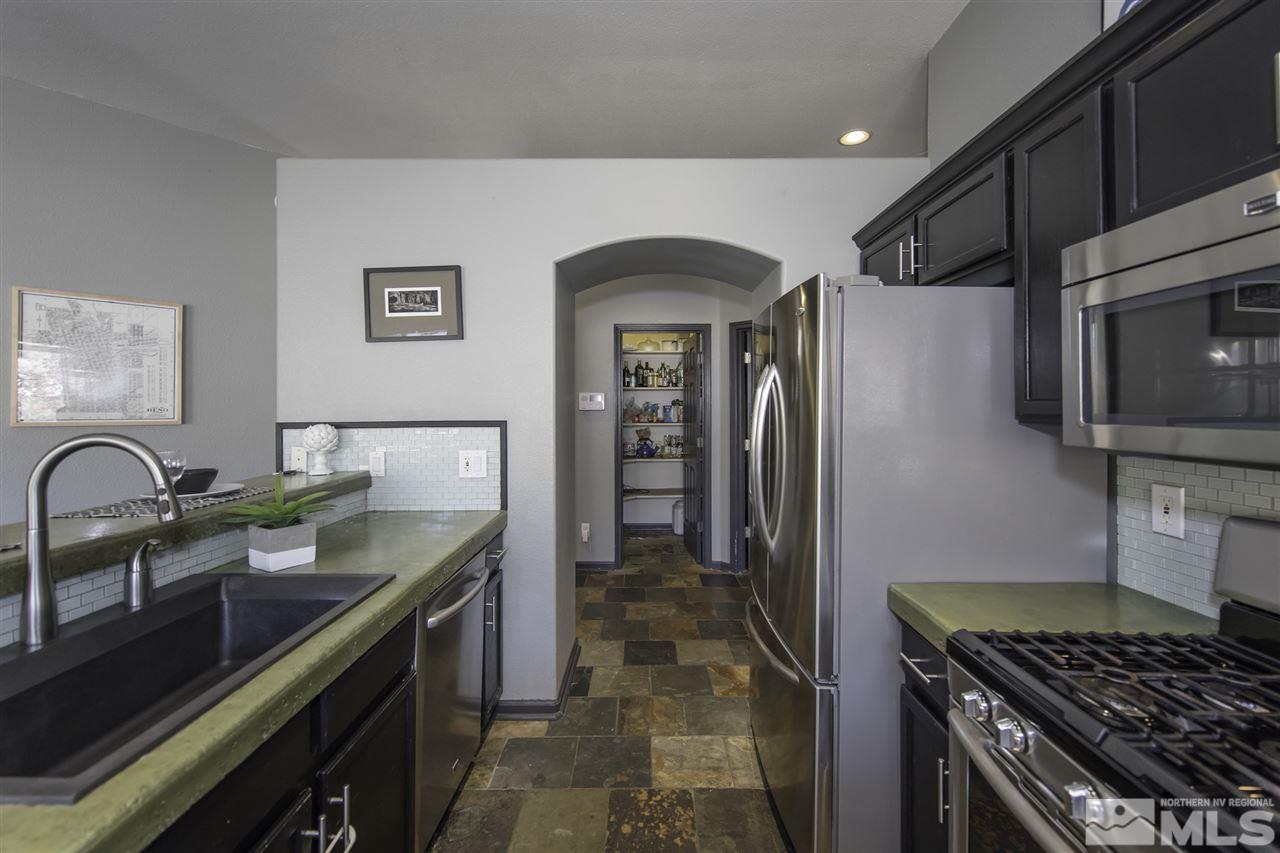 1535 Autumn Reno, NV 89511 - Photo 8 of 24 a kitchen with stainless steel appliances granite countertop a sink and a stove top oven