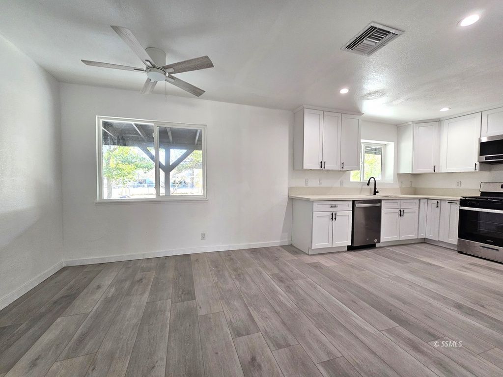 3644 Alene Avenue Ridgecrest, CA 93555 - Photo 17 of 22 a view of kitchen with wooden floor window and appliances