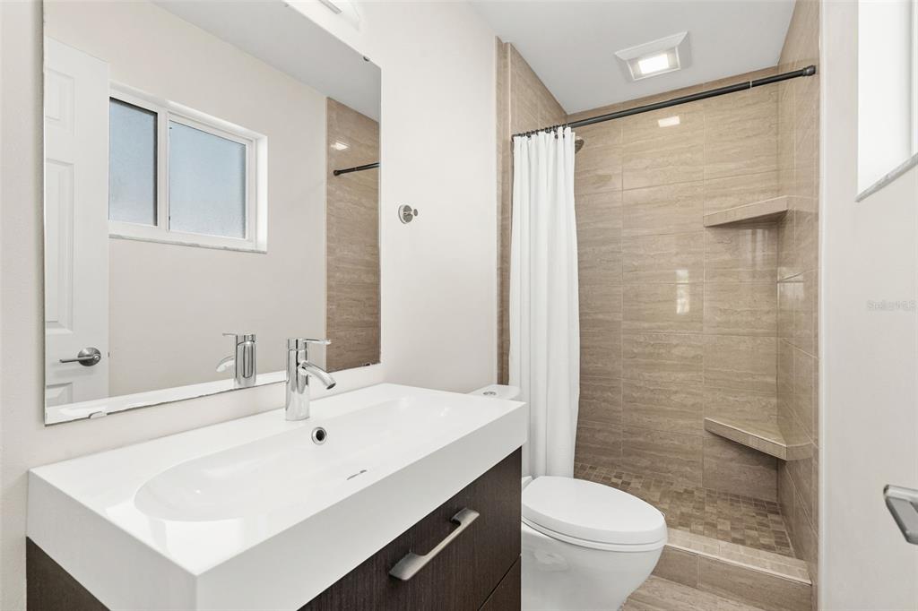 4908 Arlington Road Palmetto, FL 34221 - Photo 19 of 36 a bathroom with a sink toilet and shower