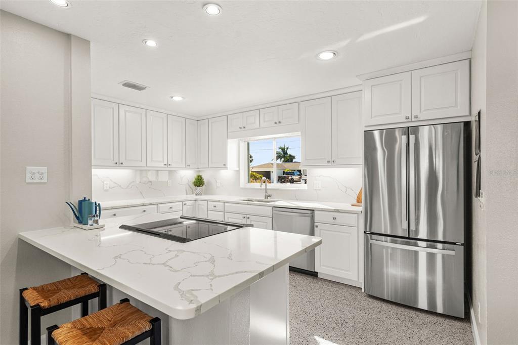 4908 Arlington Road Palmetto, FL 34221 - Photo 10 of 36 a kitchen with refrigerator and white cabinets