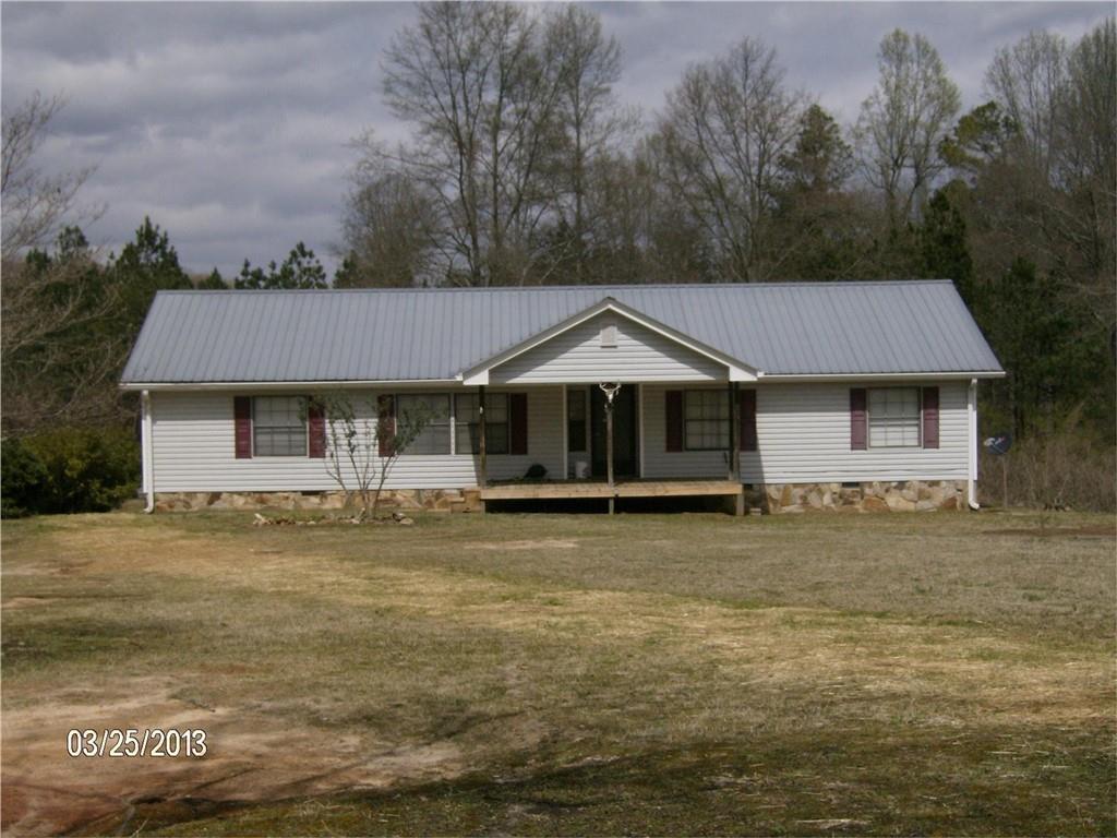 3590 Grady Smith Road Loganville, GA 30052 - Photo 1 of 3 a front view of a house with a garden