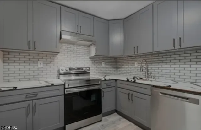 a kitchen with a sink stove and cabinets