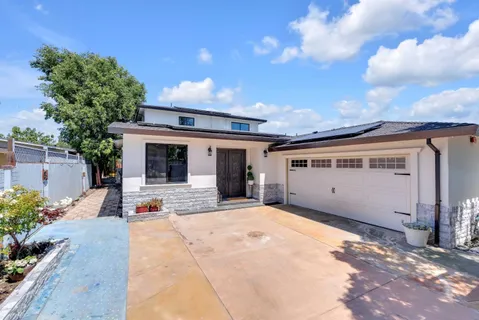 a front view of house with yard and car parked