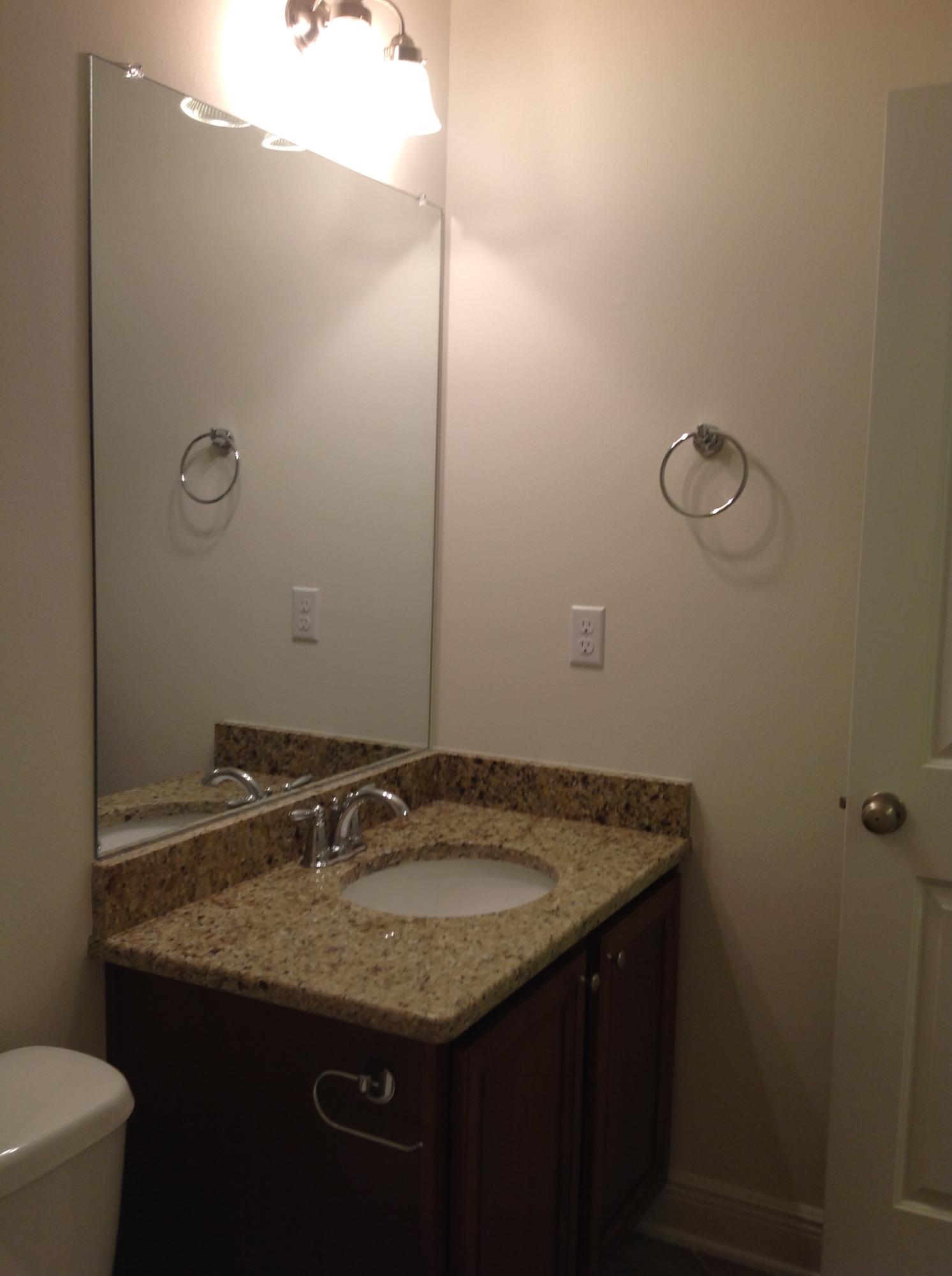 2131 Wilsons Plover Circle Navarre, FL 32566 - Photo 12 of 19 a bathroom with a granite countertop sink and a mirror