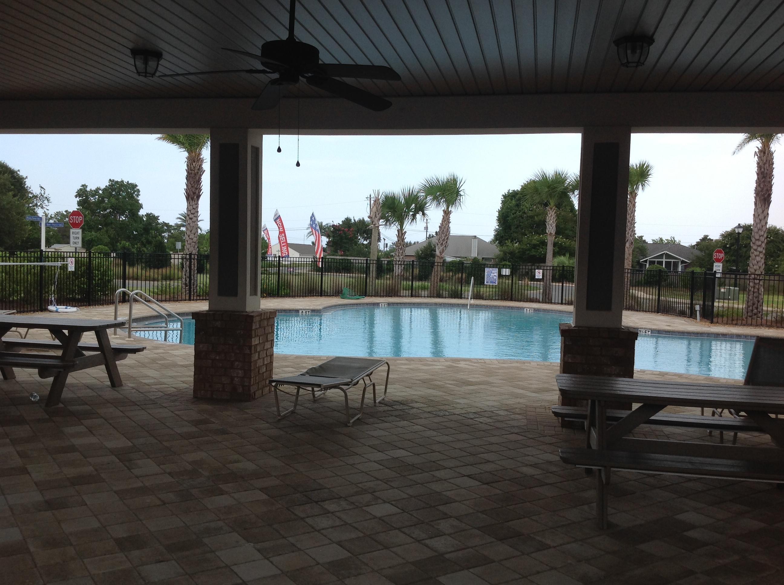 2131 Wilsons Plover Circle Navarre, FL 32566 - Photo 16 of 19 a view of a chairs and table in patio with a lake