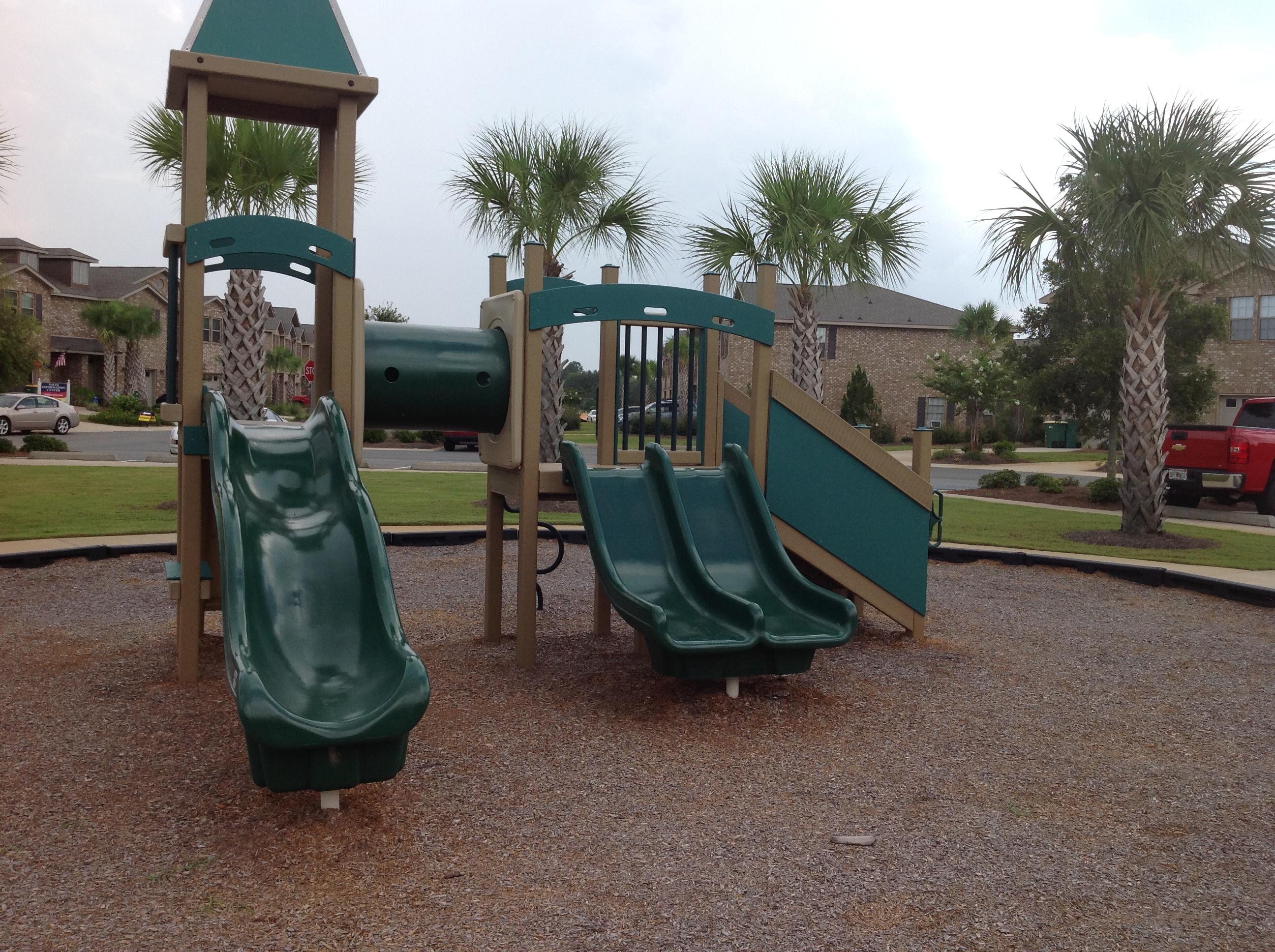 2131 Wilsons Plover Circle Navarre, FL 32566 - Photo 17 of 19 a view of a swimming pool with a bench and potted plants