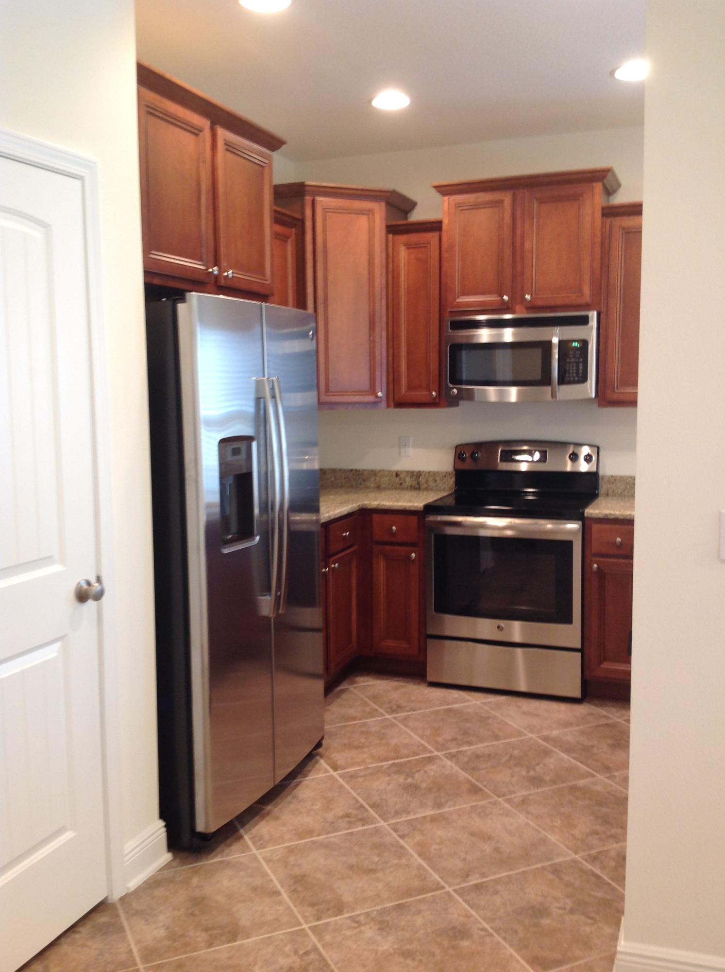 2131 Wilsons Plover Circle Navarre, FL 32566 - Photo 4 of 19 a kitchen with stainless steel appliances granite countertop a refrigerator stove and sink