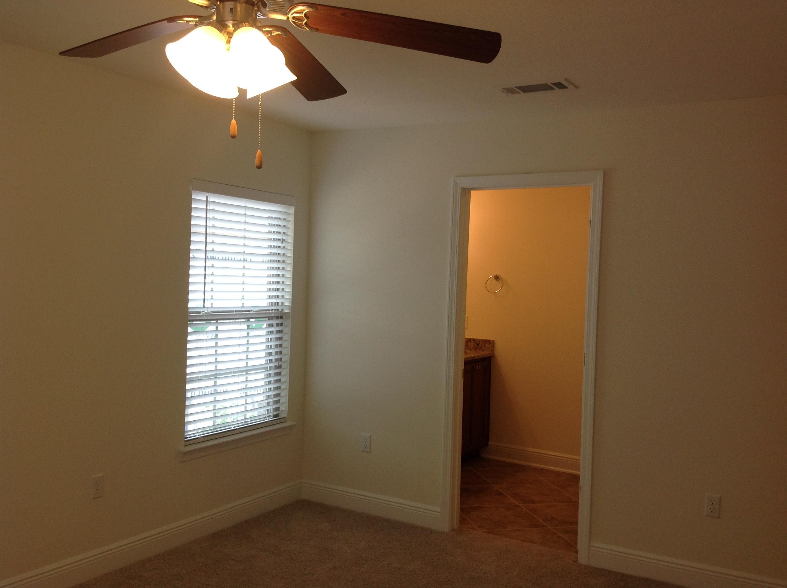 2131 Wilsons Plover Circle Navarre, FL 32566 - Photo 10 of 19 an empty room with a window and a chandelier fan