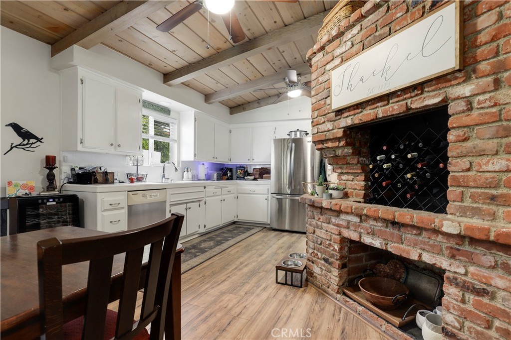 6237 Hamilton Lane La Crescenta, CA 91214 - Photo 11 of 45 a kitchen with stainless steel appliances granite countertop a stove a sink dishwasher and white cabinets with wooden floor
