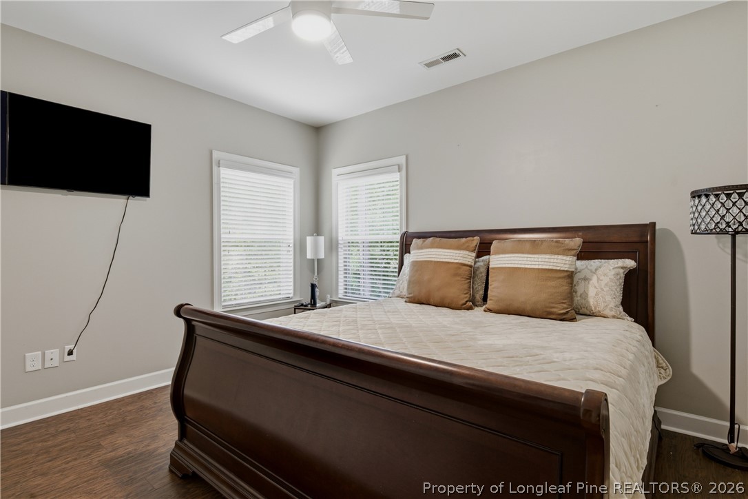 148 Heatherspring Way Spring Lake, NC 28390 - Photo 40 of 50 a bedroom with a bed a flat screen tv and a chandelier