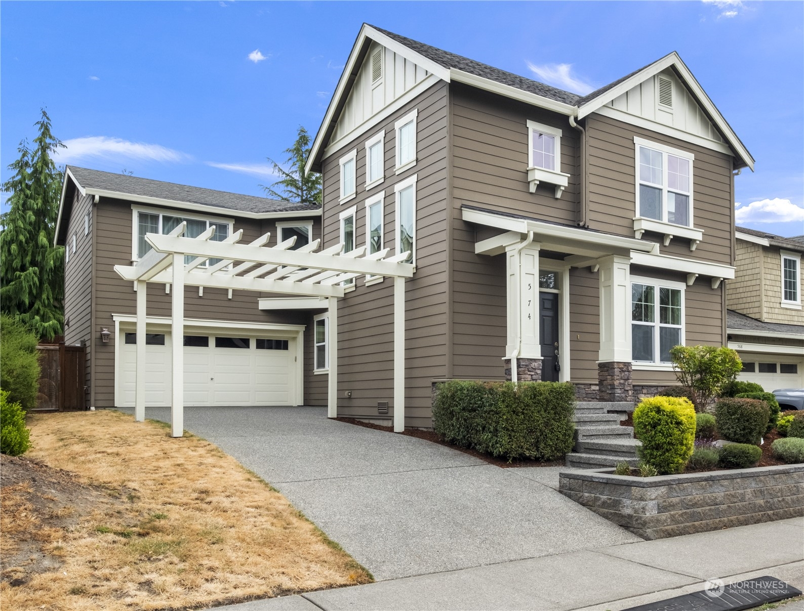 574 Lyons Place Northeast Renton, WA 98059 - Photo 1 of 39 a front view of a house with a yard