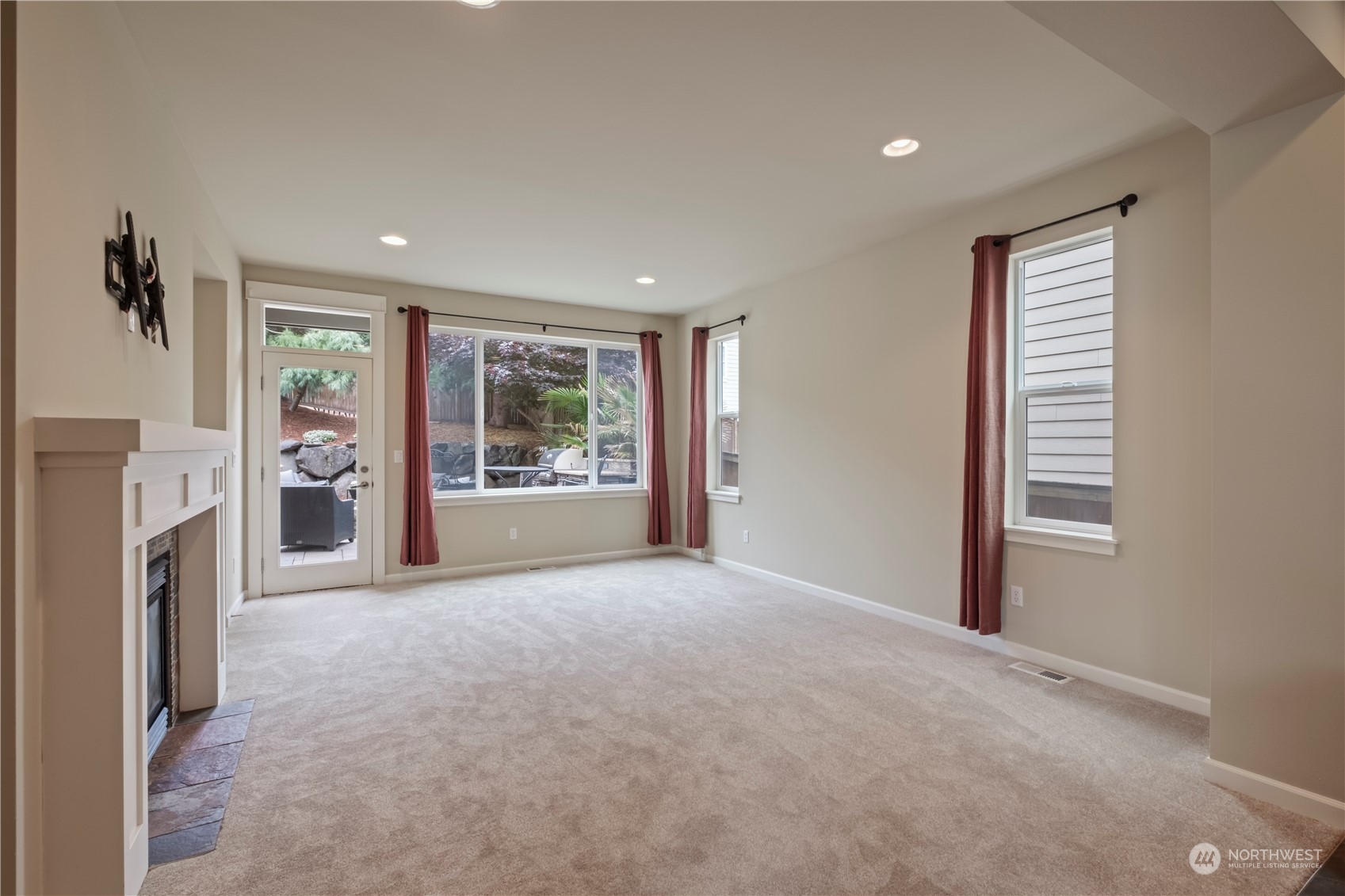 574 Lyons Place Northeast Renton, WA 98059 - Photo 14 of 39 a view of an empty room with a fireplace and a window