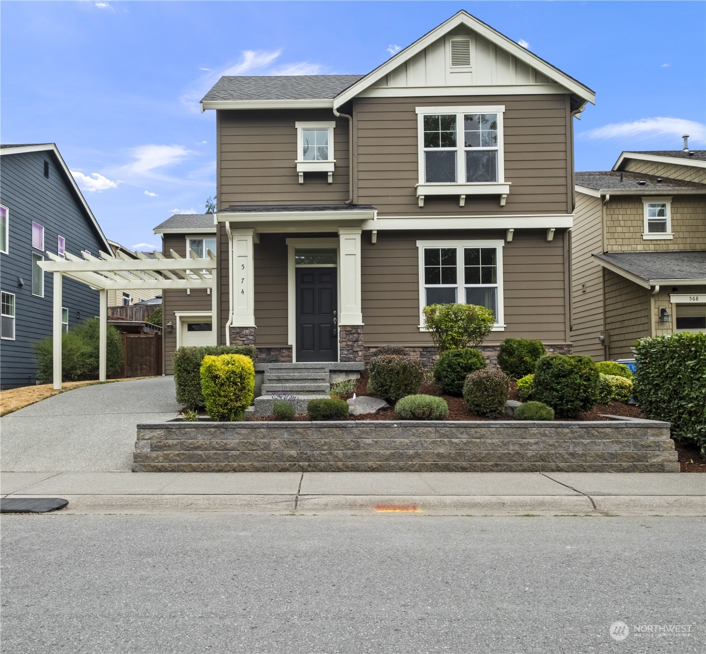 574 Lyons Place Northeast Renton, WA 98059 - Photo 2 of 39 a front view of a house with a garden