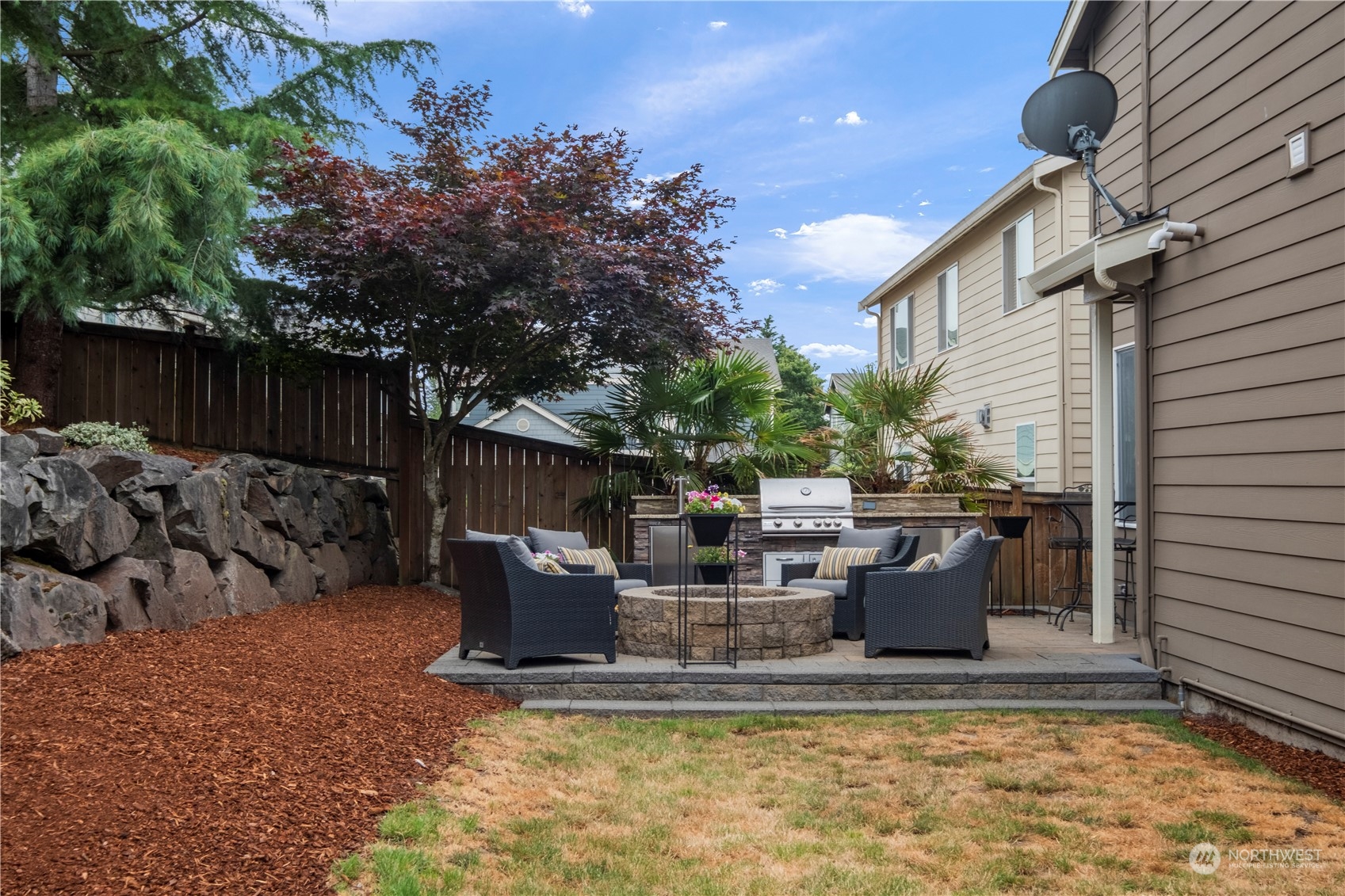 574 Lyons Place Northeast Renton, WA 98059 - Photo 31 of 39 a view of a house with backyard and sitting area