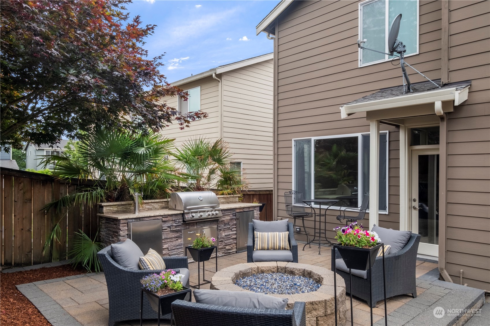574 Lyons Place Northeast Renton, WA 98059 - Photo 32 of 39 a view of a patio with couches table and chairs and potted plants