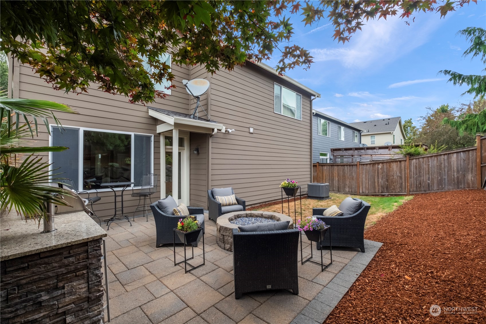 574 Lyons Place Northeast Renton, WA 98059 - Photo 34 of 39 a backyard of a house with table and chairs