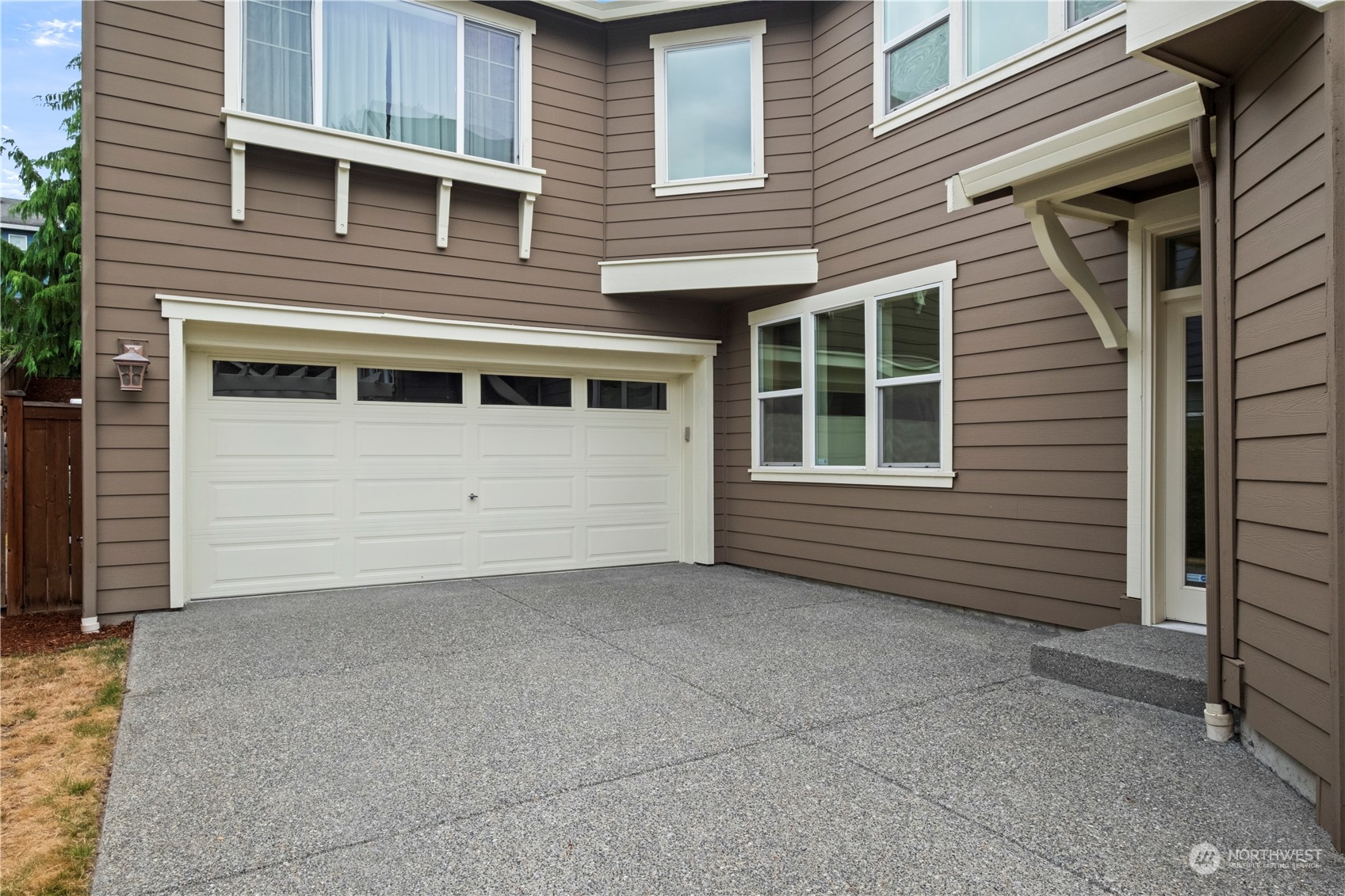 574 Lyons Place Northeast Renton, WA 98059 - Photo 4 of 39 a view of a house with more windows and brick walls