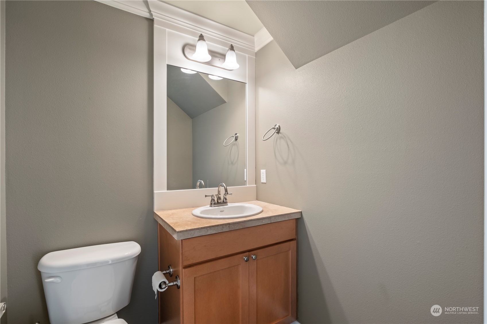 574 Lyons Place Northeast Renton, WA 98059 - Photo 8 of 39 a bathroom with a toilet sink and mirror