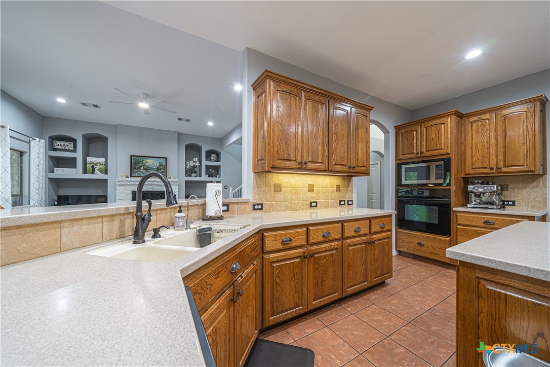 519 Long Meadow Spring Branch, TX 78070 - Photo 10 of 33 a kitchen with stainless steel appliances granite countertop a sink and cabinets