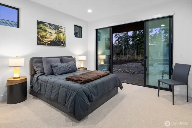 a bedroom with a bed and glass window