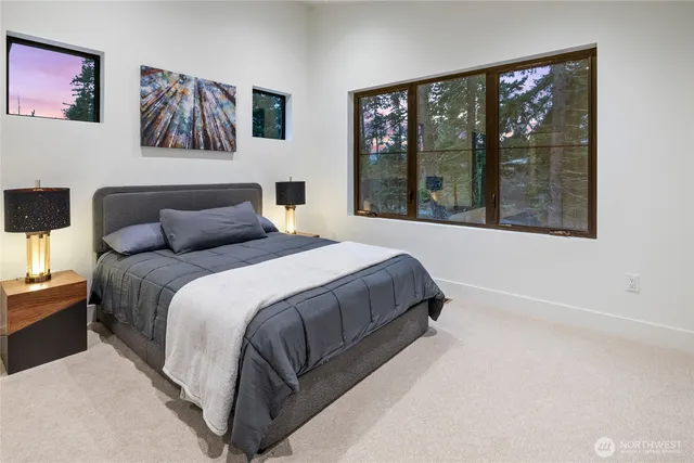 a bedroom with a large bed and a window