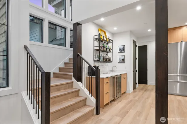 a view of entryway and hall with wooden floor