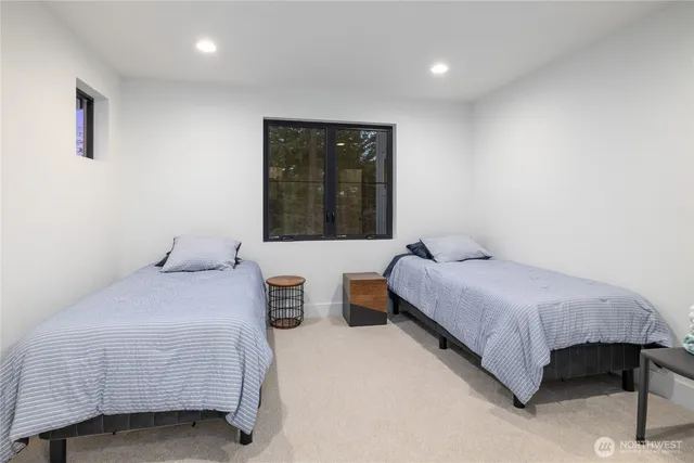 a bedroom with two beds and window