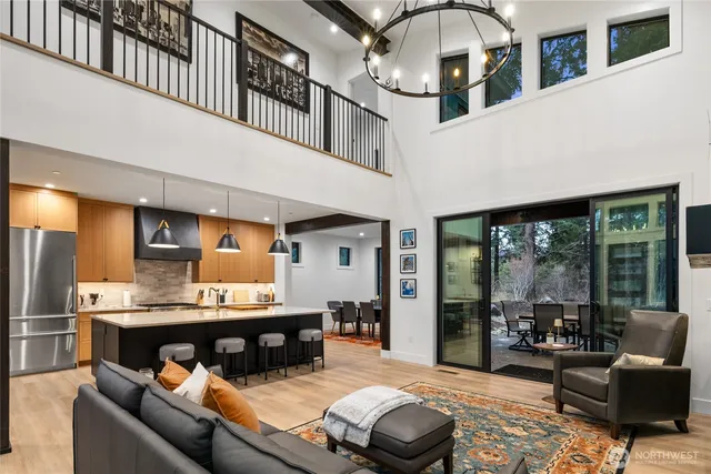 a living room with furniture and a chandelier