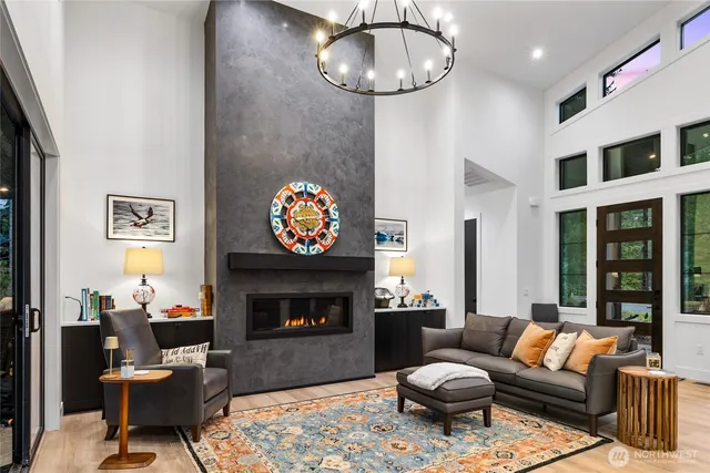 a living room with furniture a fireplace and a large mirror