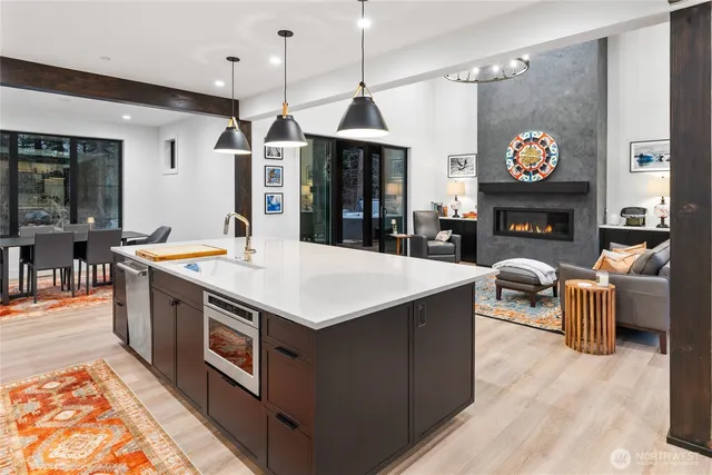 a large kitchen with stainless steel appliances granite countertop a stove and refrigerator