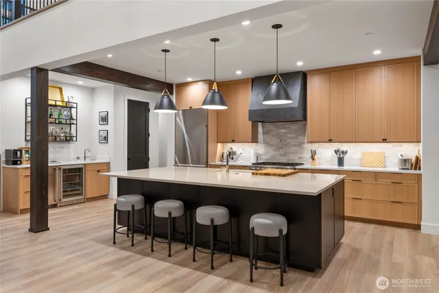 a kitchen with cabinets a counter and chairs