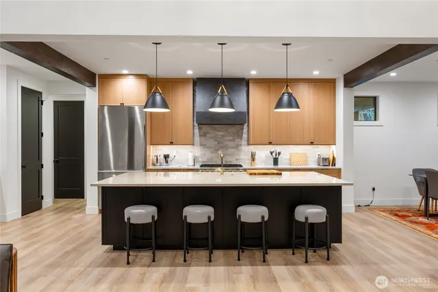 a kitchen with cabinets and chairs