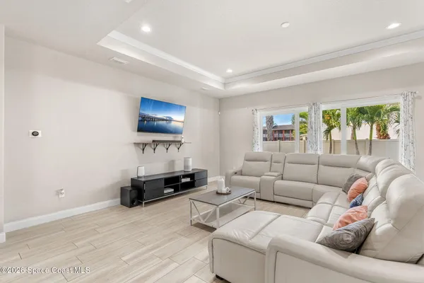 a kitchen with stainless steel appliances a dining table chairs and wooden floor