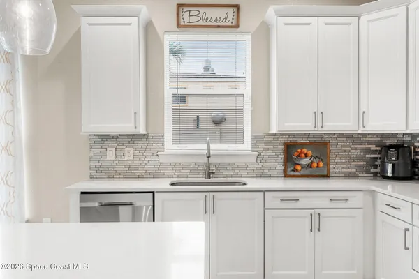 a kitchen with stainless steel appliances granite countertop a sink and a wooden cabinets