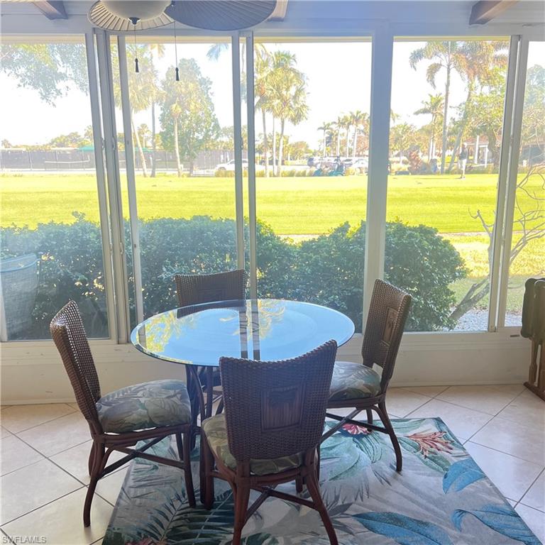 197 Harrison Road, Unit 3 Naples, FL 34112 - Photo 8 of 14 Sunroom / solarium with outdoor dining area and a ceiling fan