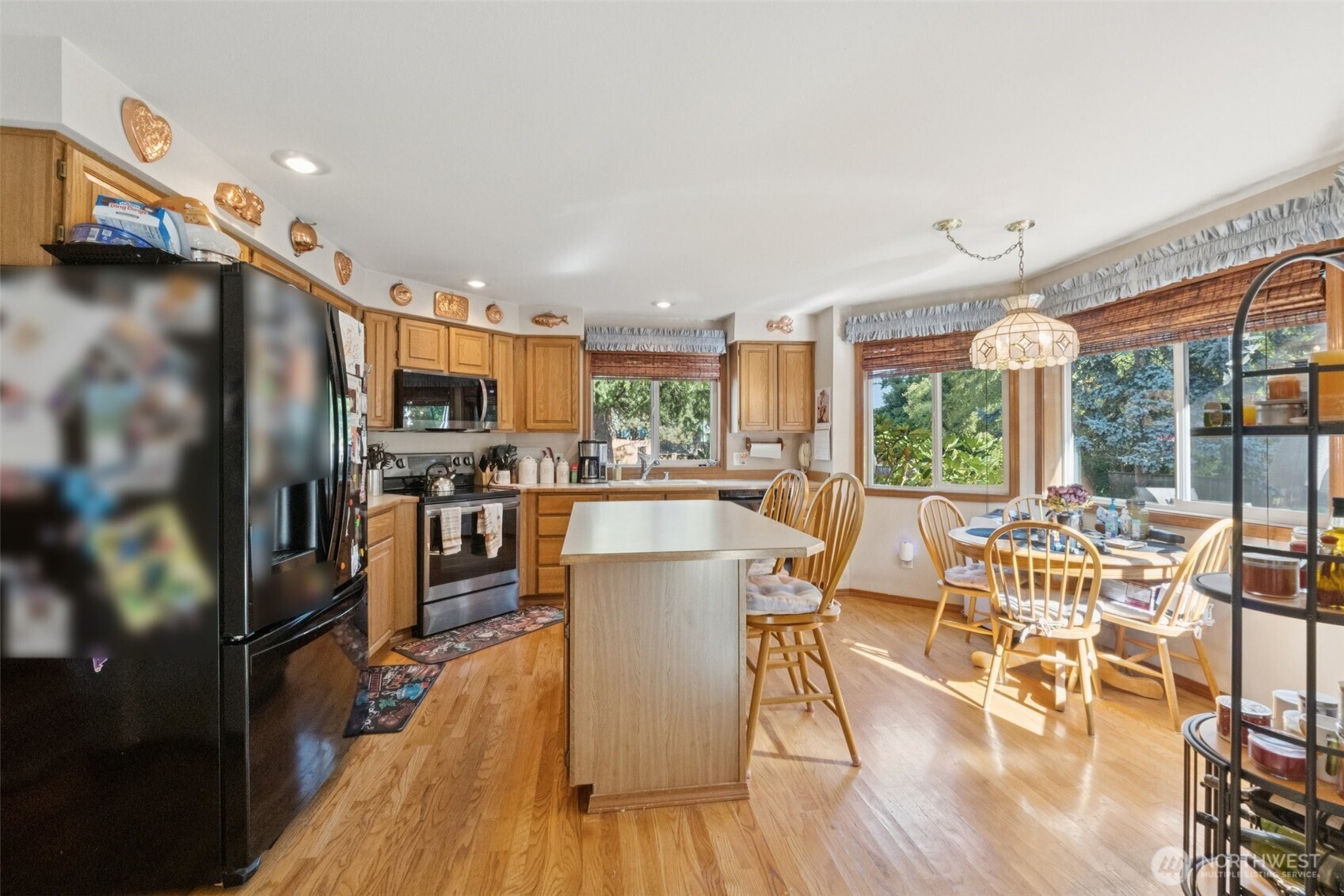 28820 52nd Place South Auburn, WA 98001 - Photo 14 of 33 a view of a dining room with furniture a kitchen view and wooden floor