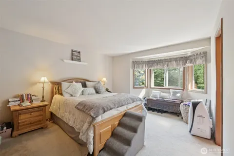 a bedroom with a bed and a desk