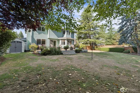 a backyard of a house with table and chairs