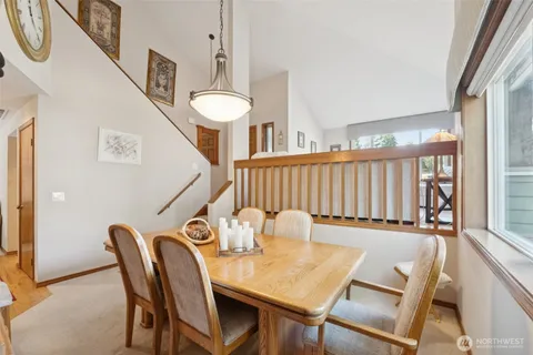 a view of a dining room with furniture and a window
