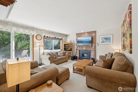 a living room with furniture large window and a fireplace