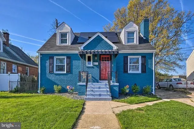 a front view of a house with a garden