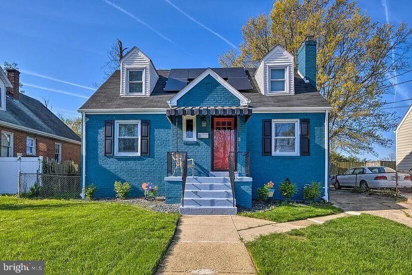 a front view of a house with a garden