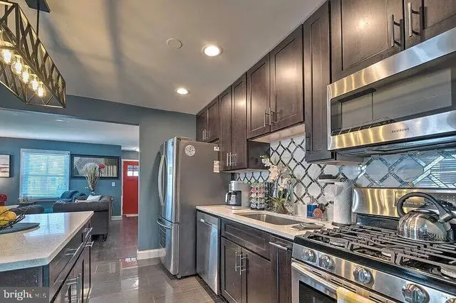 a kitchen with stainless steel appliances granite countertop a stove and a refrigerator