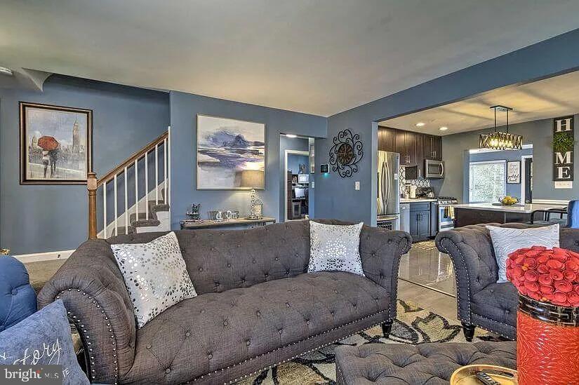 4617 Boosa Street, Unit 1 Capitol Heights, MD 20743 - Photo 6 of 19 a living room with furniture and a dining table with wooden floor
