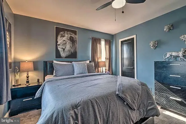 a bedroom with a bed and lamp