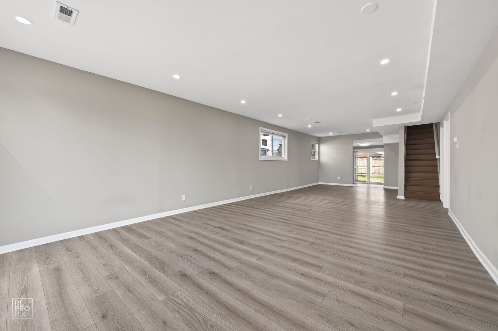 4680 West 83rd Street Chicago, IL 60652 - Photo 8 of 22 a view of an empty room with wooden floor and windows