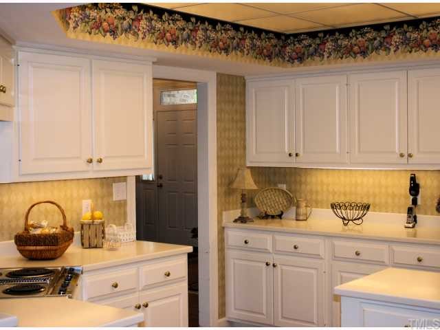 105 Cedar Ridge Way Durham, NC 27705 - Photo 4 of 12 Light and cheerful kitchen with corian countertops - lots and lots of cabinets and great work space
